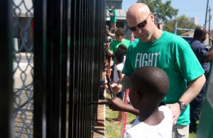 At a "Fight the Blight" event in March 2011, Mayor Mitch Landrieu paints a gate around the pool at Taylor Park in Hoffman Triangle with Laquinn Huey, who was 8 at the time. NOLA For Life Day, a continuation of those efforts, will be held Saturday at A.L. Davis Park in Central City. (UptownMessenger.com file photo by Sabree Hill)