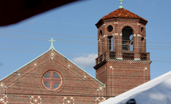 Tents sit in front of St. Henry's Catholic Church at the 22nd Annual Feast of St. Henry Mass and Reunion. Live entertainment, beer, food, and snowballs were all free at the event. (Sabree Hill, UptownMessenger.com)