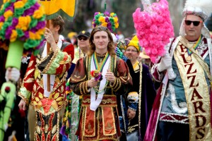 The Jefferson City Buzzards travel down St. Charles Avenue handing out flowers to crowds on Mardi Gras Day in 2012. (UptownMessenger.com file photo by Sabree Hill)