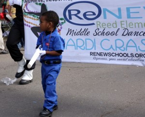 A pint-sized soldier marches in front of the ReNEW Reed Elementary middle school dance team on Napoleon Avenue during Mardi Gras 2013. (UptownMessenger.com file photo by Robert Morris)