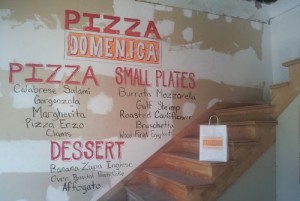 A sample menu for the planned Pizza Domenica chalked onto the wall of the building during August's open house. (Robert Morris, UptownMessenger.com)
