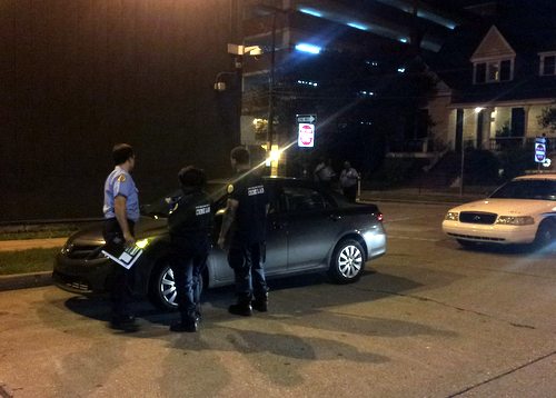 Police examine a gray Toyota Corolla found at Coliseum and Delachaise streets near Touro Infirmary, believed to have been involved in the Felicity Street shooting. (Robert Morris, UptownMessenger.com)