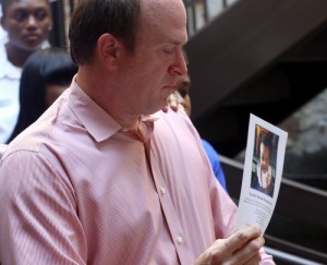 Glen Armantrout, CEO of Cafe Reconcile, holds a photo of 1-year-old Londyn Samuels, slain in Monday's shooting. (Robert Morris, UptownMessenger.com)