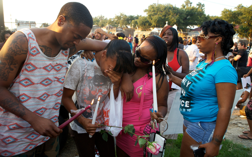 Ashley Samuels, a relative of Londyn Samuels, is comforted as she cries at the vigil Friday night. (Sabree Hill, UptownMessenger.com)
