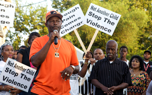 DJ Jubilee speaks out against gun violence at the vigil. (Sabree Hill, UptownMessenger.com)