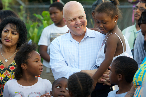 Mayor Mitch Landrieu holds Janae Thomas, 6, after she reads the poem, "Hey Black Child" at the vigil for Londyn Samuels Friday night. (Sabree Hill, UptownMessenger.com)