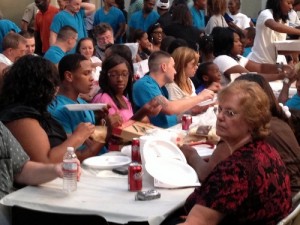 Graduates eat home-cooked meals on white tablecloths. (photo by Timothy D. Ray for UptownMessenger.com)