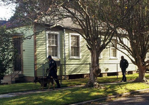 A police dog and his handlers round the corner of Pitt and Lowerline streets while searching for a burglary suspect Monday afternoon. (Robert Morris, UptownMessenger.com)