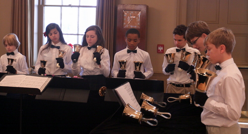The St. Paul's Bell Choir performs in Poydras Home's renovated reception hall during the opening ceremonies. (Robert Morris, UptownMessenger.com)