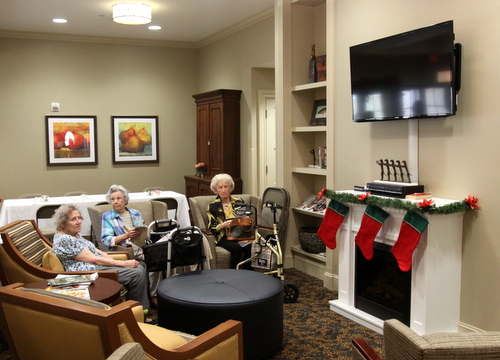 Poydras Home residents relax in a living room area of the new Oak House building after the opening ceremony. (Robert Morris, UptownMessenger.com)
