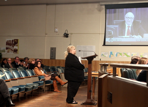 Rhonda Lange of Demo Diva speaks before the Historic District Landmarks Commission on Thursday, with members of the First Spanish-American Baptist Church in the background. (Robert Morris, UptownMessenger.com)