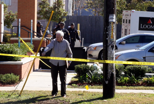 The coroner's investigator gives instructions at the scene. (Robert Morris, UptownMessenger.com)