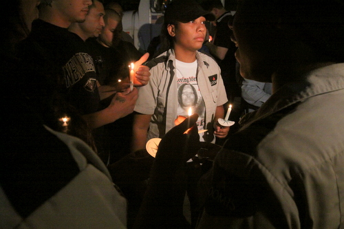 Loomis employees light one another's candles at the vigil. (Robert Morris, UptownMessenger.com)