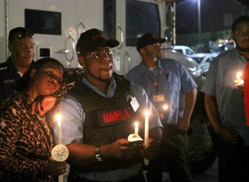 Mourners hold candles at the vigil. (Robert Morris, UptownMessenger.com)