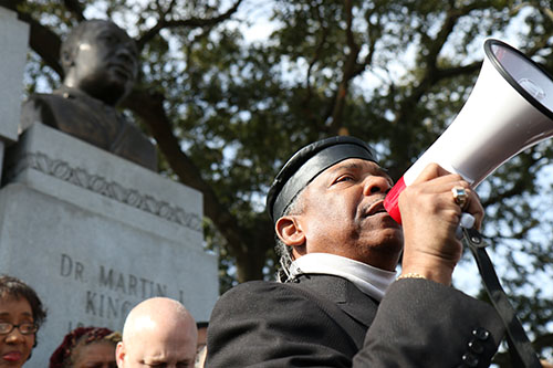 Rev. Norwood Thompson addresses the crowd on South Claiborne Avenue. (Zach Brien, UptownMessenger.com)
