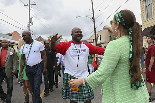 Jason Williams (right), newly elected City Councilman at Large, embraces a crowd member. Williams marched with heavyweight boxing champion Evander Holyfield (left).