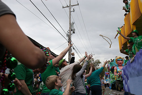 Spectators receive beads from one of the parades many floats.
