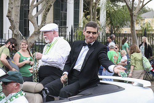 Orleans Parrish district attorney throws beads to onlookers.
