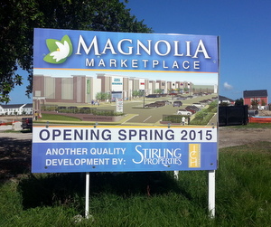 A sign on the Magnolia Marketplace site promises a 2015 grand opening. (Robert Morris, UptownMessenger.com)