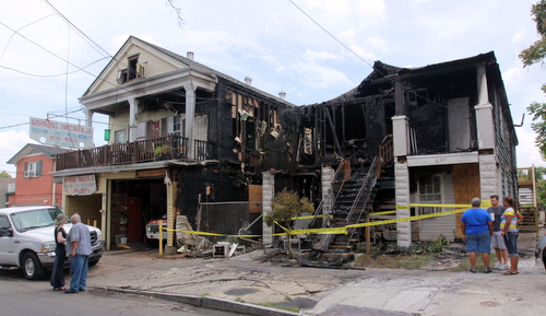 Neighbors and supporters discuss damage to houses in the 800 block of Cadiz Street. (Robert Morris, UptownMessenger.com)
