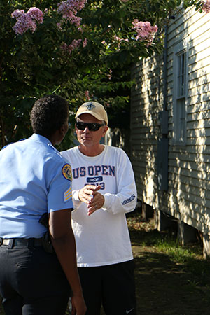 Sgt. Yolanda Jenkins (left) and Chris Barbe (right), a new uptown resident, talk before Wednesday's crime walk began. (Zach Brien, UptownMessenger.com)