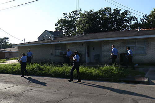 Sixth district NOPD officers pass out crime stoppers pamphlets on Laurel Street during Wednesday's Anti-Crime Walk. (Zach Brien, UptownMessenger.com)