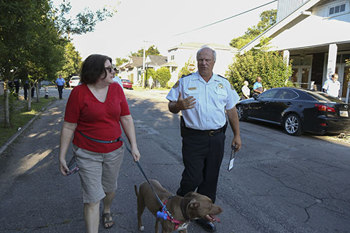 Captain Bob Bardy (right), discusses crime cameras with Meredith McLannhan and her dog Rosie (left). (Zach Brien, UptownMessenger.com)