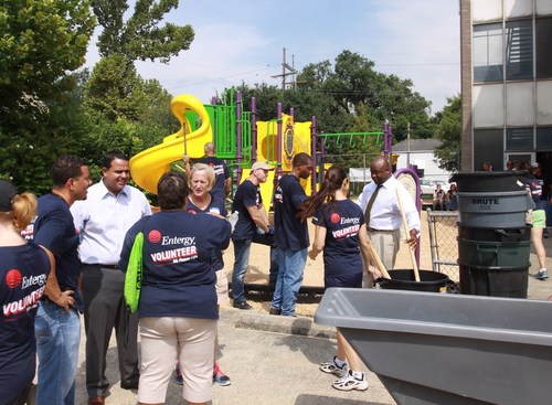 Dozens of Entergy volunteers are joined by City Councilmen Jared Brossett and Jason Williams as they prepare the playground at the former Benjamin Banneker campus for KIPP Believe students to move in next week. (Robert Morris, UptownMessenger.com)