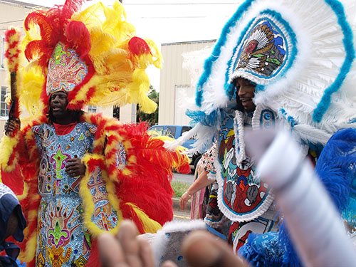 Leroy Boss, flag boy of the Flaming Arrows, and Louis Snoop" Thomas, flag boy of the Golden Blades outside of the Ashe Cultural Arts Center during Sunday's ceremony. (Zach Brien, UptownMessenger.com)