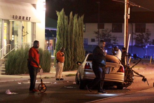 Police investigate the fatal crash on Magazine Street. (Robert Morris, UptownMessenger.com)