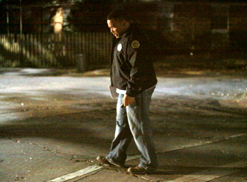 NOPD Detective Jerry Baldwin looks for evidence on Willow Street near Lowerline following a robbery Friiday, Dec. 12. (Robert Morris, UptownMessenger.com)