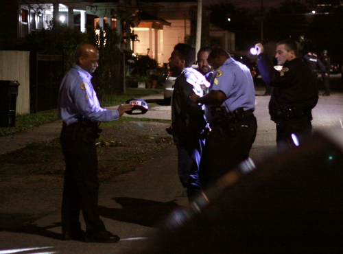 Police take a suspect into custody Sunday night at Cadiz and Loyola. (Robert Morris, UptownMessenger.com)