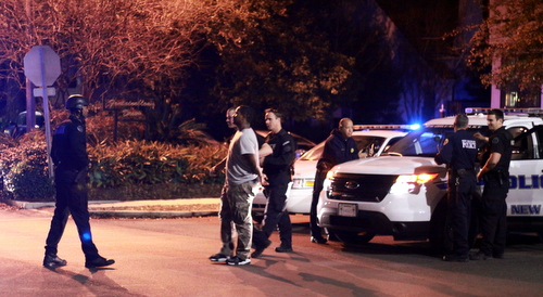 Police lead a suspect to a waiting patrol car following a manhunt that closed several streets around Broadway and Fontainebleau on Monday, Jan. 12. (Robert Morris, UptownMessenger.com)