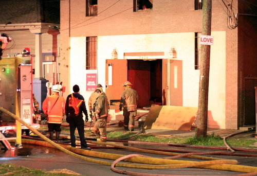 Firefighters look for hotspots after a blaze at 2420 Martin Luther King Boulevard. (Robert Morris, UptownMessenger.com)