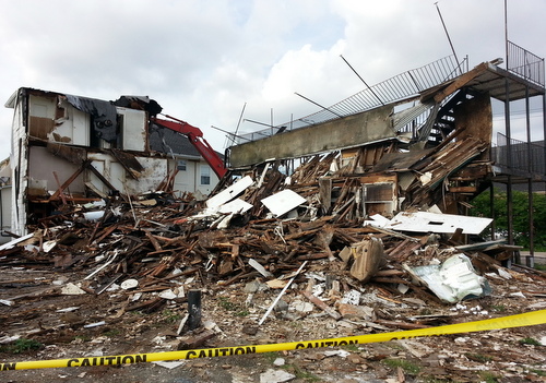 The apartment complex at 1900 Amelia Street, midway through its demolition. (Robert Morris, UptownMessenger.com)