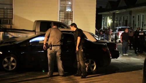 Investigators examine a Honda Civic recovered as part of Thursday's robbery investigations that matches the description of a vehicle taken Sunday in a robbery on Laurel Street. (Robert Morris, UptownMessenger.com)