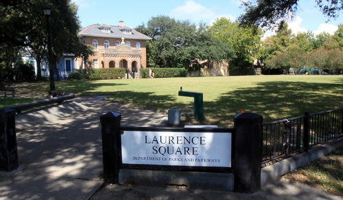 A woman and child walk through Laurence Square park on Wednesday morning, about 12 hours after a robbery was reported there Tuesday night. (Robert Morris, UptownMessenger.com)