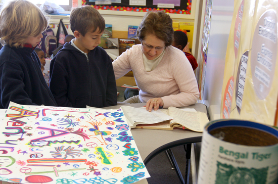 Teacher Elena Countiss helps Austyn Millet, 8, and  Aidan  Sierra, 8,  in a 2nd grade Spanish immersion classroom at the The International School of Louisiana Wednesday afternoon. (Sabree Hill, UptownMessenger.com)