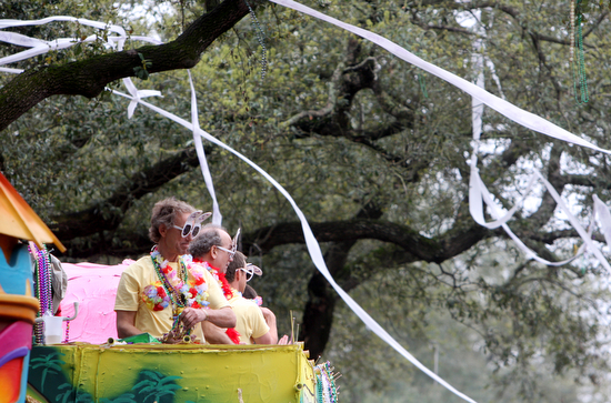 Rolls of toilet paper stream from the trees above Krewe of Tucks floats in 2011. (Sabree Hill, UptownMessenger.com)