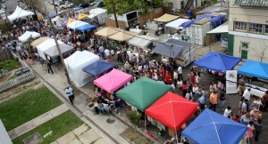 Crowds fill Freret Street between the vendor tents during the Freret Street Festival in 2013. (UptownMessenger.com file photo by Robert Morris)