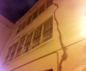 Temporary patching can be seen on long cracks on a courtyard wall at the International School of Louisiana's Camp Street campus Wednesday night. (Robert Morris, UptownMessenger.com)