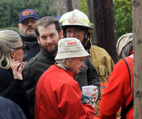 Ann Trufant, center, speaks to firefighters while her grandson, Will, stands with her.  (Robert Morris, UptownMessenger.com)