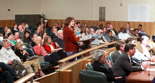 A resident asks the City Council for a compromise location for the proposed Carrollton Boosters sports complex as members of the Audubon Commission and Carrollton Boosters listen. (Robert Morris, UptownMessenger.com)