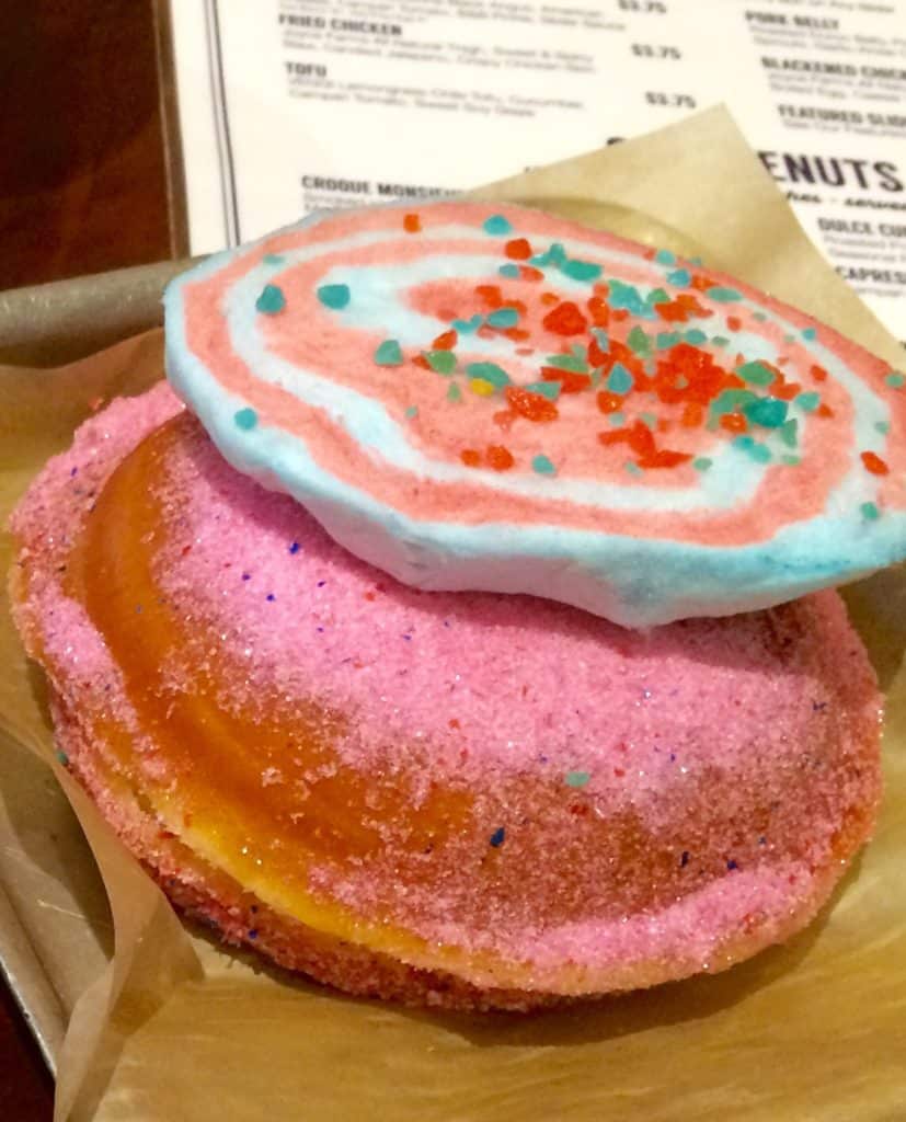 Dough-La-Mode, Warm Griddled Donut Filled with Creole Creamery Cotton Candy Flavored Ice Cream and topped with "Poof "Cotton Candy, garnished with Pop-Rocks Froeba)