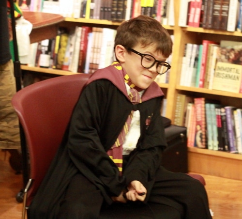 A young fan acts out a scene as Harry Potter. (Robert Morris, UptownMessenger.com)