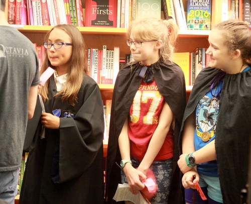 Sisira Holbrook, Emma Rioux and Allie Flemington -- all seventh-graders at Lusher Charter School -- stand at the front of the line to receive the first copies of "Harry Potter and the Cursed Child" when it is released at midnight. (Robert Morris, UptownMessenger.com)