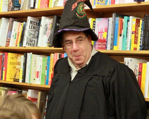 Octavia Books owner Tom Lowenburg casts a mischievous smile over the collection of wizards lined up for the latest Harry Potter book. (Robert Morris, UptownMessenger.com)