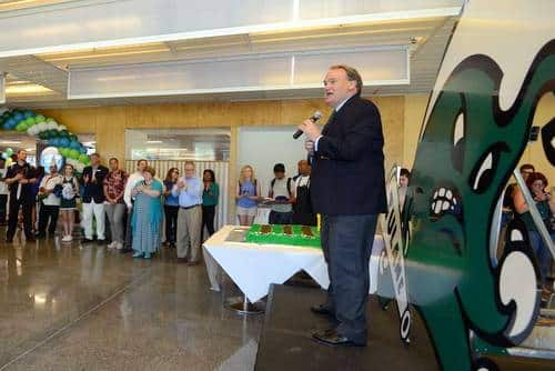 Tulane University president Michael Fitts stands in front of a new "Angry Wave" rendering as he celebrates the reopening of the university's Lavin-Bernick Center food court with new offerings. (courtesy photo)