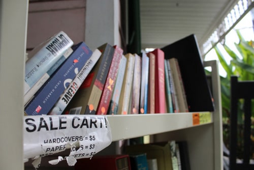 At Maple Street Book Shop, the used books that are on the shelves for too long go on the sale cart on the porch. The books sell for $2, $3 or $5. (photo by Dannielle Garcia).