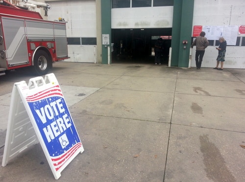 Voters study the ballot choices outside the fire station polling place on Magazine Street in the Irish Channel. (Robert Morris, UptownMessenger.com)